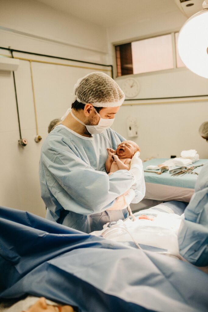 A doctor carrying a newborn