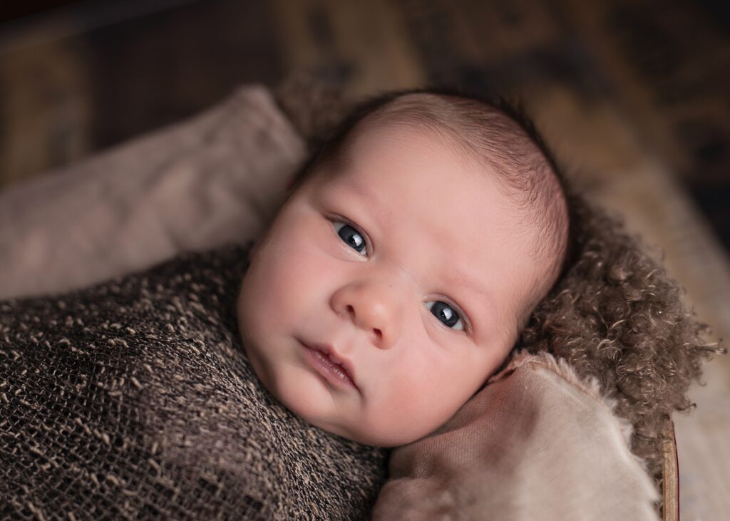 A baby looking at the photographer. A compounding pharmacy can help you with customized medications for your babies and kids. 